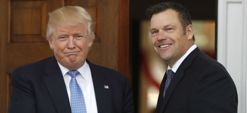 President-elect Donald Trump greets Kansas Secretary of State, Kris Kobach, as he arrive at the Trump National Golf Club Bedminster clubhouse on Sunday in Bedminster, N.J.