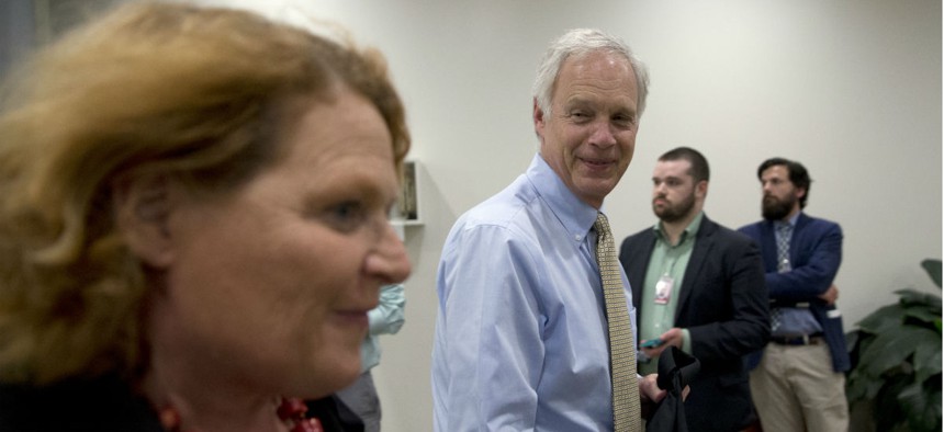 Sen. Heidi Heitkamp, left, spearheaded a letter from 50 lawmakers to Sen. Ron Johnson, left, and other authors of a postal reform bill, to register their concerns.