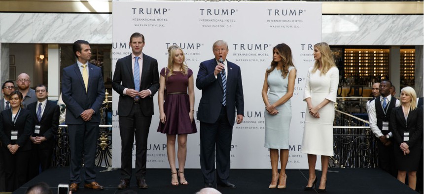 Then candidate Donald Trump, with his wife and grown children, speaks during the Oct. 26 grand opening of the Trump International Hotel in the Old Post Office in Washington.