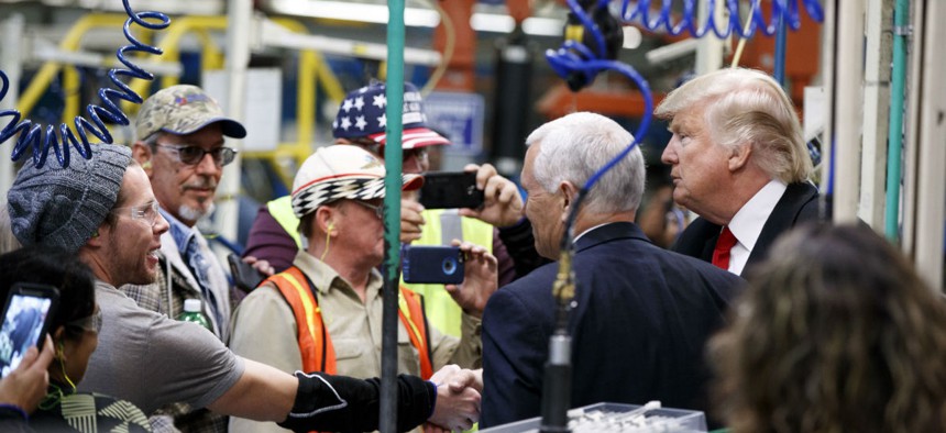 President-elect Donald Trump and Vice President-elect Mike Pence talk with workers during a visit to the Carrier factory in Indianapolis on Dec. 1.
