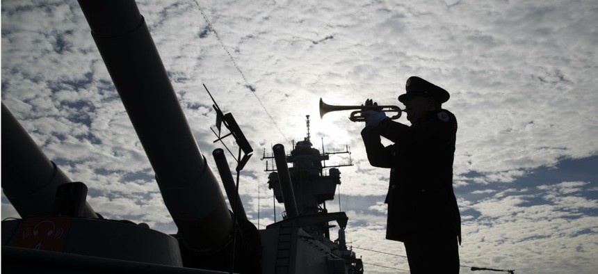 Greg Murphy plays the Navy Hymn during a ceremony commemorating the 75th anniversary of the Japanese attack on Pearl Harbor, on board The Battleship New Jersey Museum and Memorial in Camden, Dec. 7. 