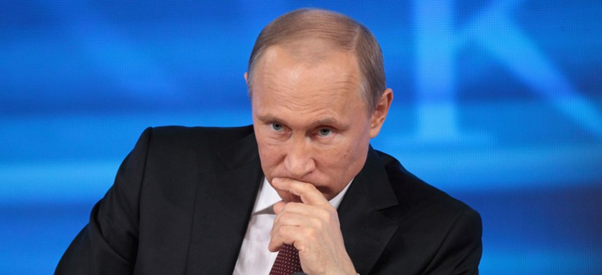 Vladimir Putin listens to a question in 2015 during a press conference.