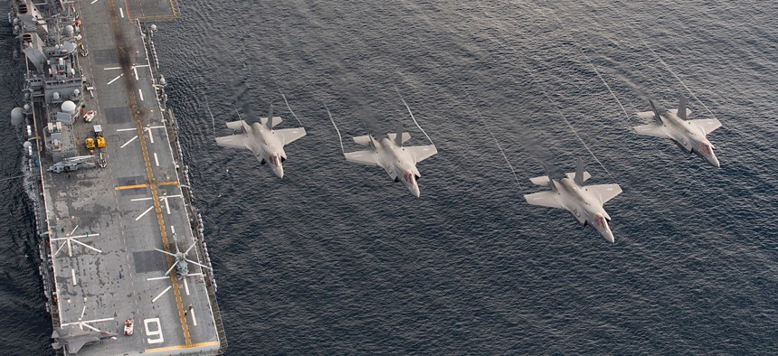 F-35Bs fly over the USS America earlier this year during sea trials.