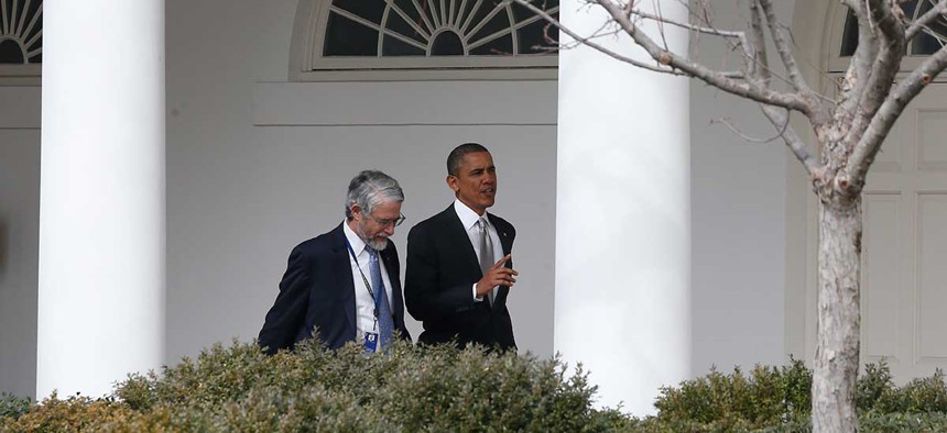 Barack Obama walks with John P. Holdren, Assistant to the President for Science and Technology and Director of the White House Office of Science and Technology Policy in 2014.