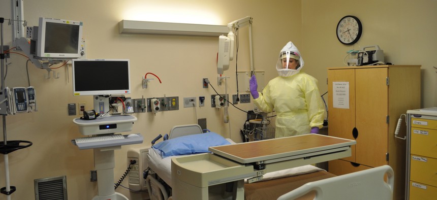 A NIH Clinical Center Special Clinical Sudies Unit nurse stands in one of the unit’s patient care rooms. 