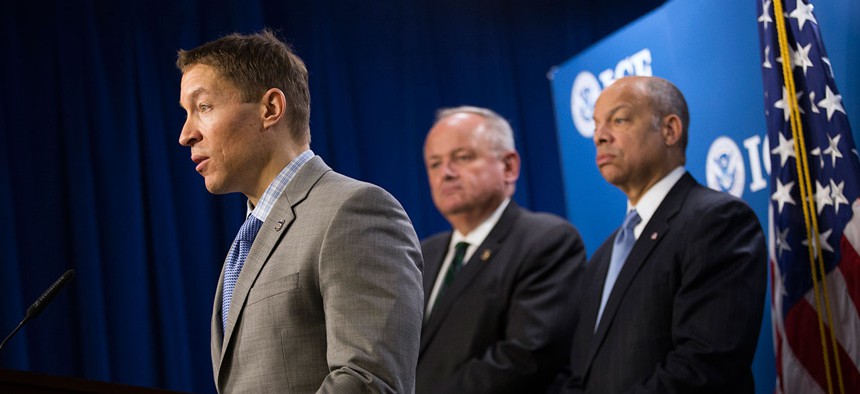 Daniel Ragsdale, left, speaks at a 2014 news conference at the ICE headquarters.