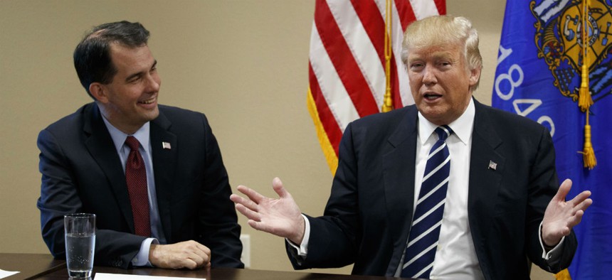 Wisconsin Gov. Scott Walker (left) joins Donald Trump at a meeting with small business leaders during the presidential campaign. 