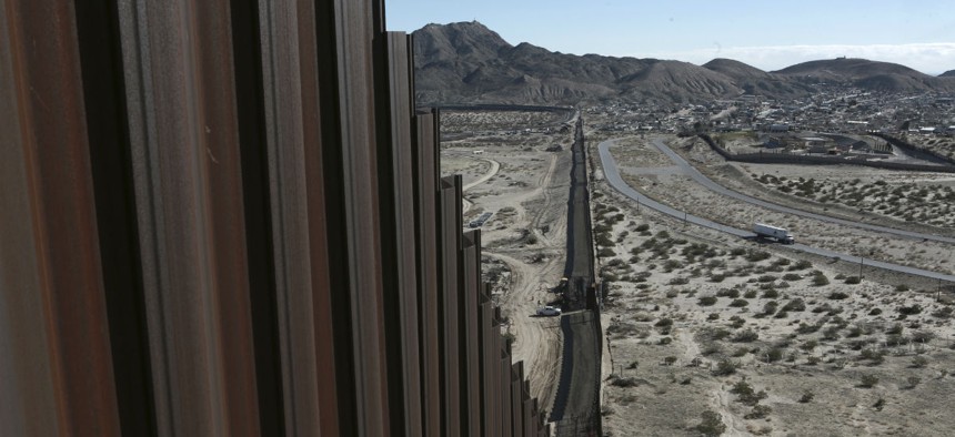 A truck drives near the Mexico-US border fence, on the Mexican side, separating the towns of Anapra, Mexico and Sunland Park, New Mexico, in January.