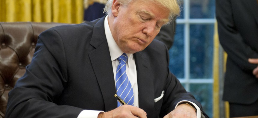 President Trump signs executive orders on Jan. 23. 