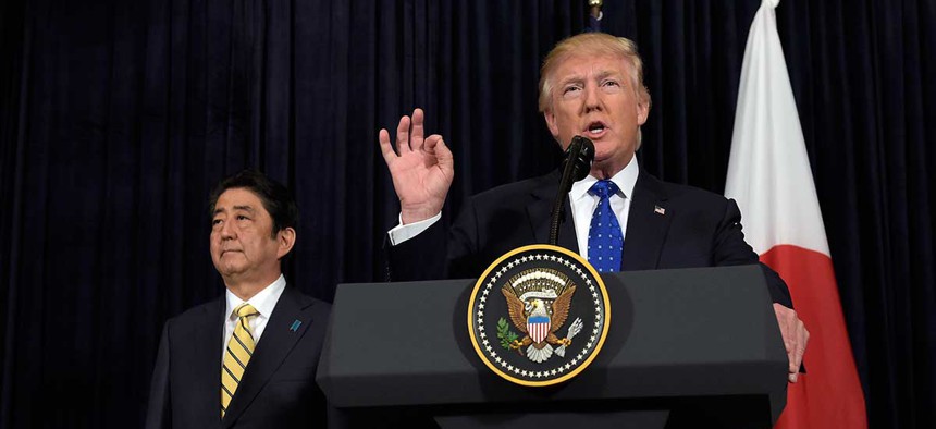 President Donald Trump speaks as Japanese Prime Minister Shinzo Abe listens on Saturday at Mar-a-Lago.