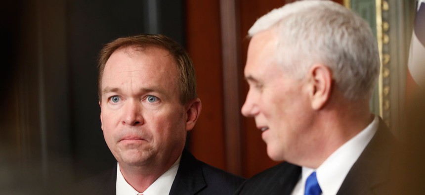 Vice President Mike Pence looks to Mick Mulvaney, Director of Office of Management and Budget in the White House complex in Washington, Thursday, Feb. 16, 2017, during a swearing in ceremony.