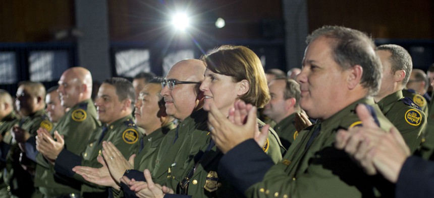 Border Patrol Officers applaud as President Donald Trump is introduced before speaking at the Homeland Security Department Jan. 25.