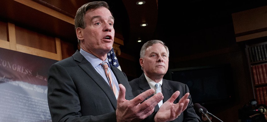 Senate Intelligence Committee Vice Chairman Sen. Mark Warner, D-Va., left, with Committee Chairman Sen. Richard Burr, R-N.C., speaks during a news conference on Capitol Hill on Wednesday.