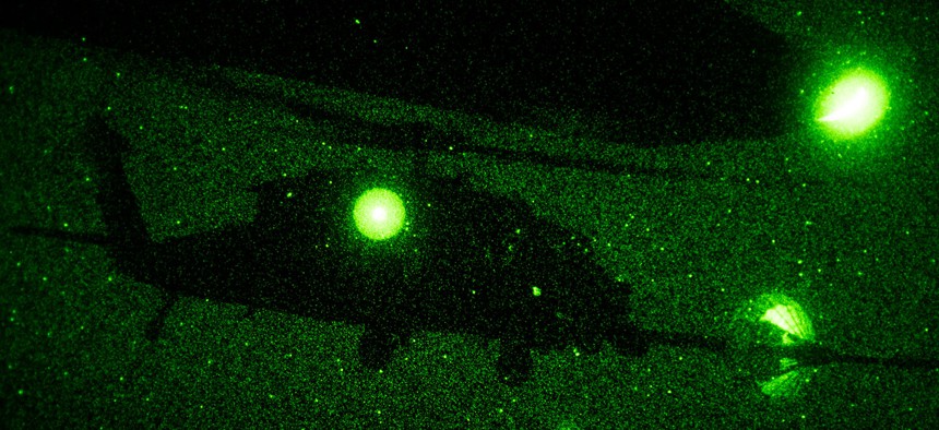  HH-60 Pavehawk from the 303rd Expeditionary Rescue Squadron, performs a night-time Helicopter Air-to-Air Refuel (HAAR) with a C-130 Hercules from the 82nd Expeditionary Rescue Squadron during a night training flight over Djibouti, Africa, March 20, 2017.