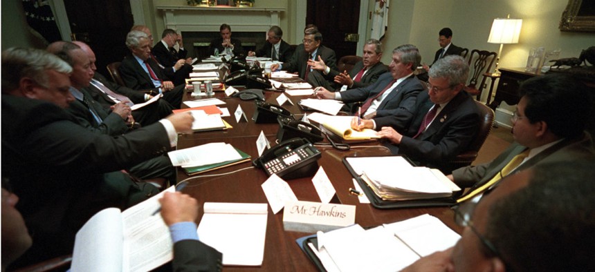 Days after the 9/11 attacks, then-President George W. Bush meets with advisers at the White House to discuss the impact of the terrorist attacks on the airline and insurance industries. 