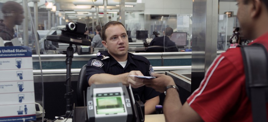 A CBP Officer processes an incoming passenger at the Newark International Airport in 2010.