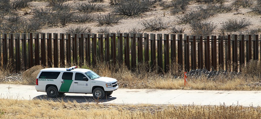 A CBP truck drives along the border fence in Arizona in 2011.