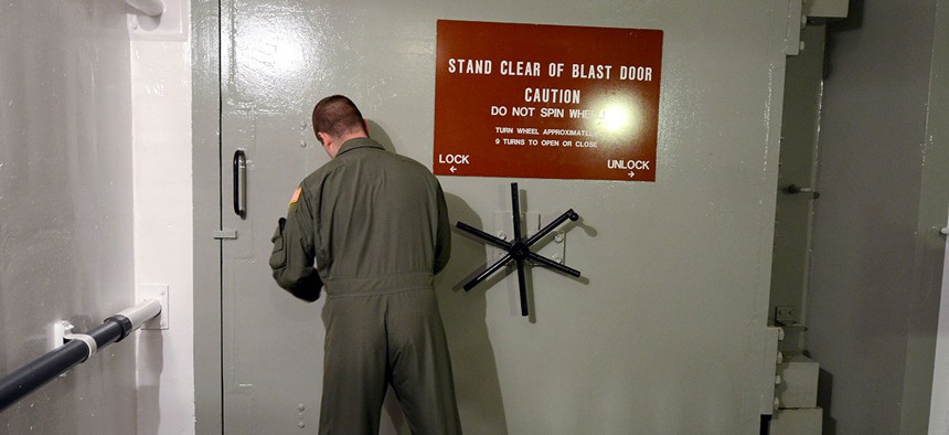 1st Lt. Phil Parentrau opening the blast door leading to the underground control room at an ICBM launch control facility near Minot, N.D. in 2014.