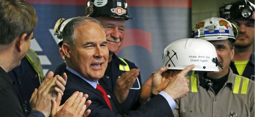EPA Administrator Scott Pruitt holds up a hardhat he was given during a visit to Consol Pennsylvania Coal Company's Harvey Mine in Sycamore, Pa.