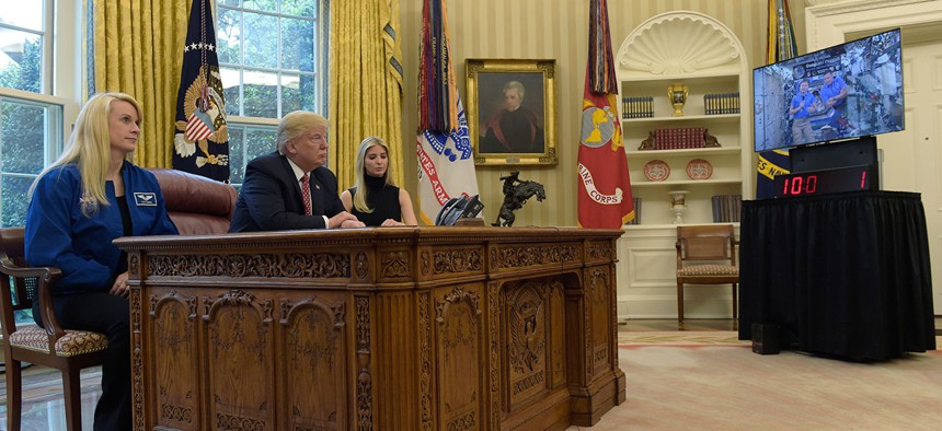 President Donald Trump, flanked by NASA astronaut Kate Rubins, left, and his daughter Ivanka Trump, speaks with International Space Station Commander Peggy Whitson and Jack Fischer, Monday.