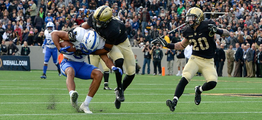 An Air Force player is tackled during the Army-Navy game in November.