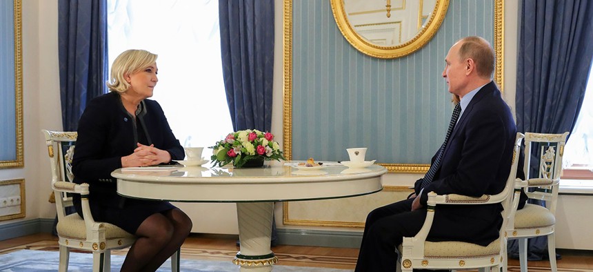 Vladimir Putin speaks to French far-right presidential candidate Marine Le Pen, in the Kremlin in Moscow in March.