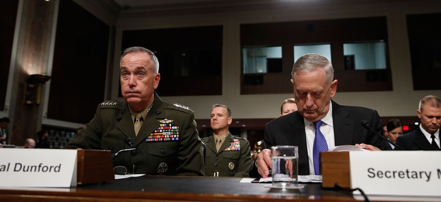 Joint Chiefs Chairman Gen. Joseph Dunford, left, and Defense Secretary Jim Mattis prepare to testify on Capitol Hill in Washington, Tuesday June 13, 2017, before the Senate Armed Services Committee.
