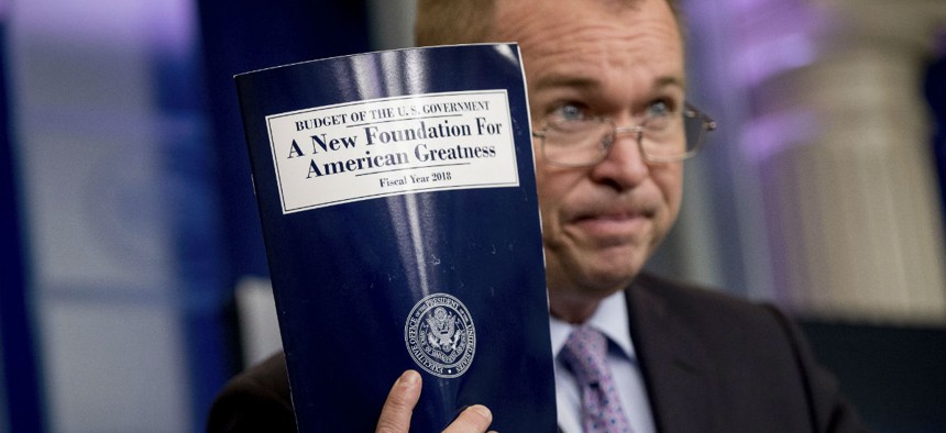 OMB Director Mick Mulvaney holds up a copy of the fiscal 2018 budget proposal. With agencies still in transition, OMB took the reins in crafting the document. 