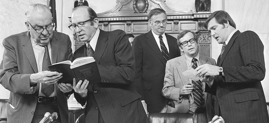 After the Senate Watergate Committee hearings concluded on Friday, August 3,1973, Senators and counsel held a session. From left are Senator Sam J. Ervin, Sam Dash, Senator Lowell P. Weicker, Senator Howard H. Baker, and the author.