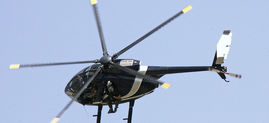 Blackwater security contractors are seen inside a helicopter above central Baghdad in 2007.