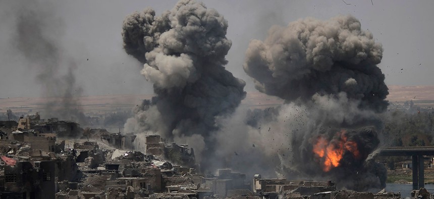 Airstrikes target Islamic State positions on the edge of the Old City a day after Iraq's prime minister declared "total victory" in Mosul on Tuesday.