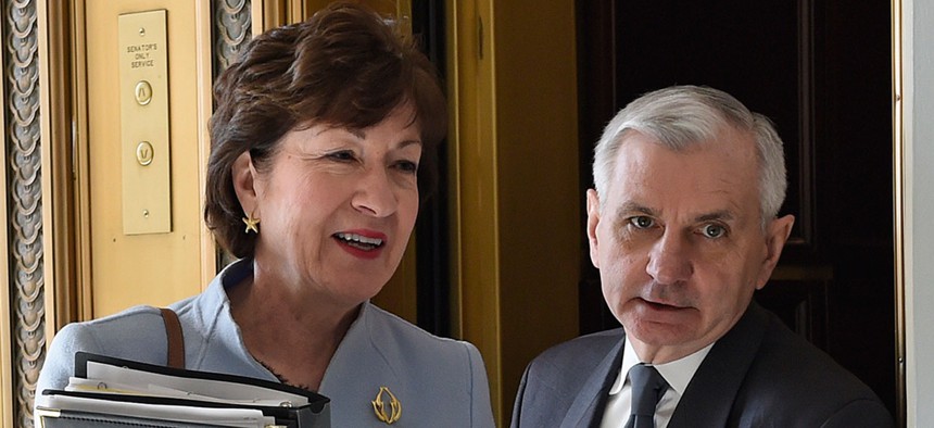Susan Collins and Jack Reed walk together in 2015 on Capitol Hill.