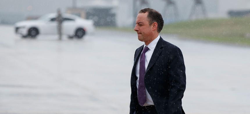 Priebus walks to boards Air Force One at Andrews Air Force Base on Friday morning.