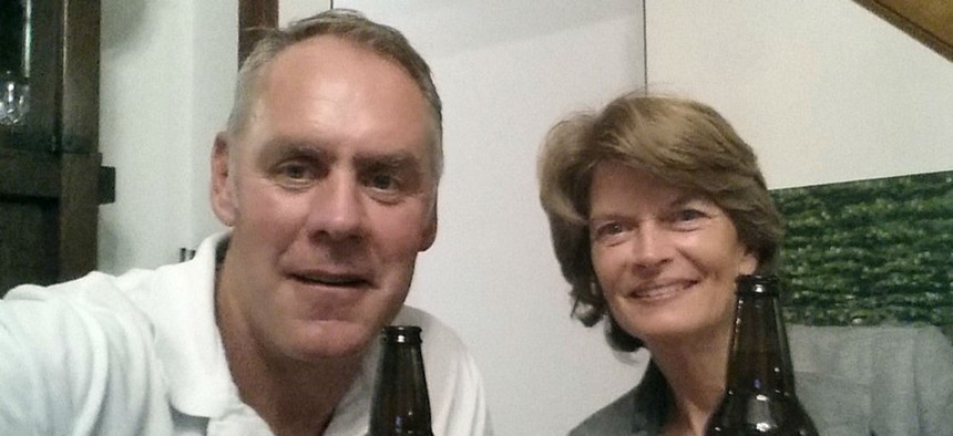 Interior Secretary Ryan Zinke and Sen. Lisa Murkowski, R-Alaska, have a beer in Washington. Zinke tweeted the photo to show the two were getting along, after reports that he threatened Murkowski over her health care vote. 