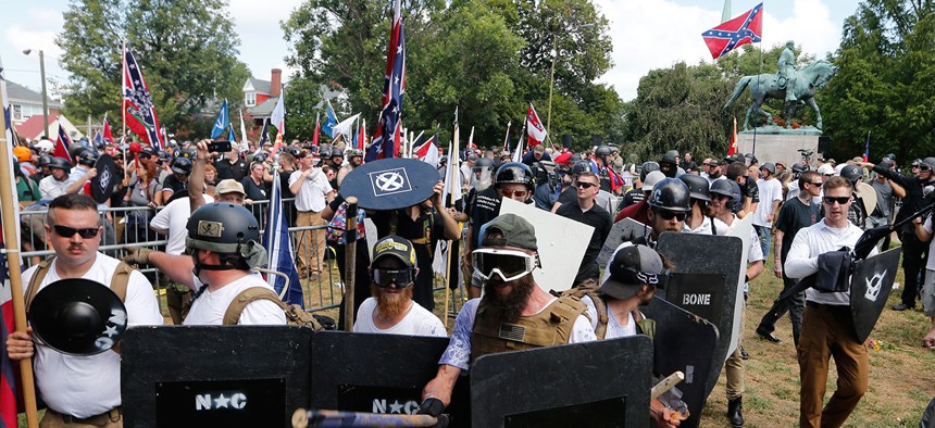White nationalist demonstrators hold their ground as they clash with counter demonstrators in Lee Park in Charlottesville on Saturday.