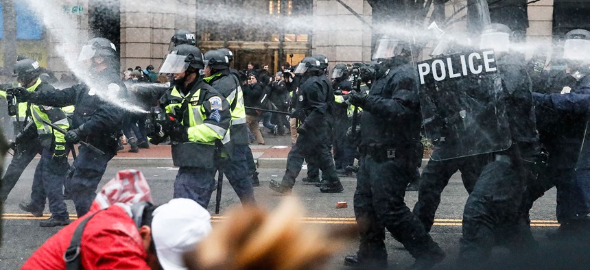 Police fire pepper spray at protestors during a demonstration in downtown Washington on Jan. 20.