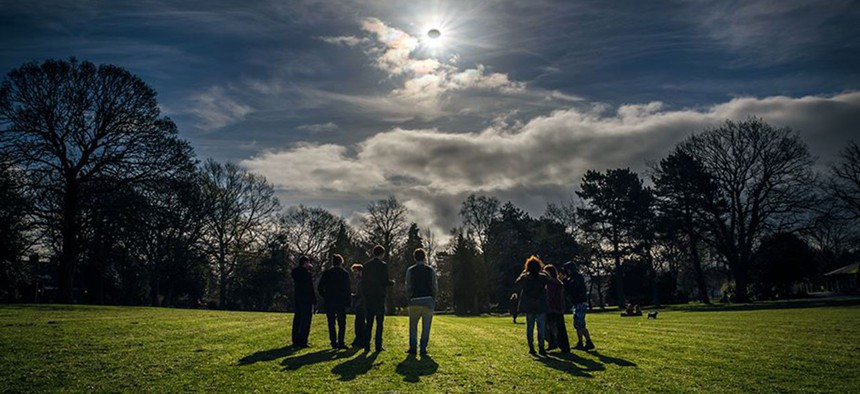 People watch a partial eclipse in Belfast, Northern Ireland in 2015.
