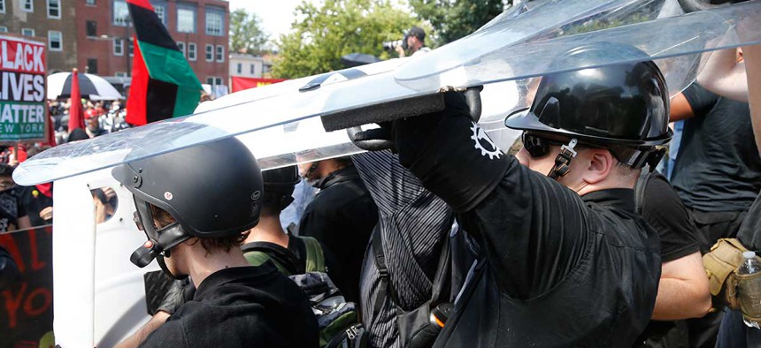 White nationalists hold shields as violence erupts in Charlottesville on Aug. 12.