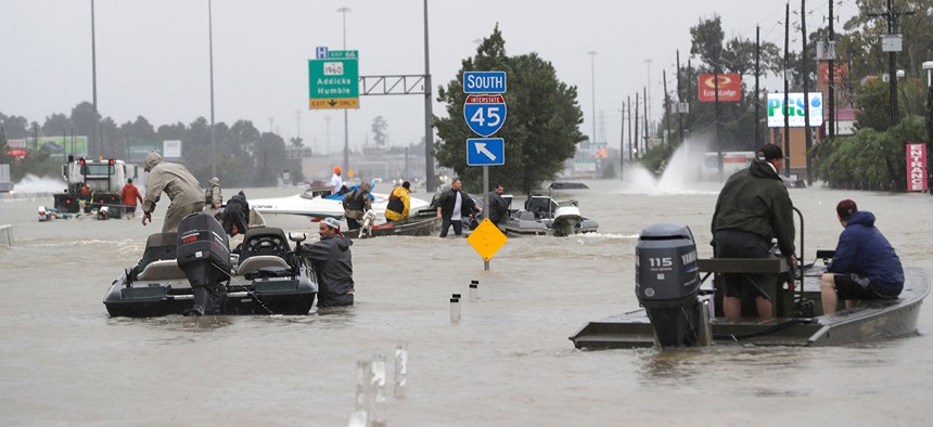 Volunteer rescue boats make their way into a flooded subdivision to rescue stranded residents as floodwaters rise in Spring, Texas on Monday.