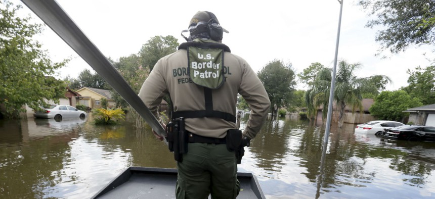 U.S. Border Patrol Agent Steven Blackburn looks out while standing on the bow of an air boat during a search a rescue operation in Houston.
