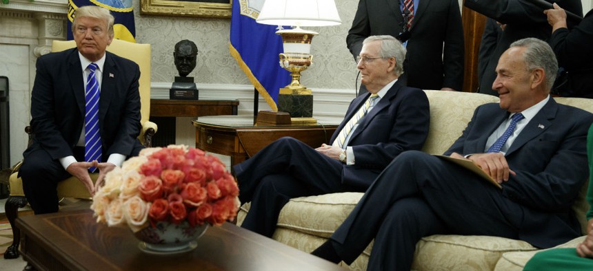 President Trump meets with congressional leaders including Senate Majority Leader Mitch McConnell (center) and Minority Leader Chuck Schumer on Wednesday. Trump sided with Democrats' plan for a three-month spending and debt limit extension. 