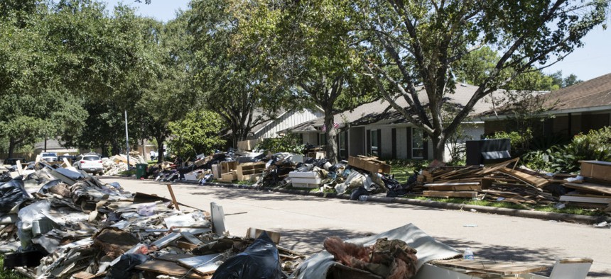 Debris damaged by flooding lines the streets after Hurricane Harvey. 