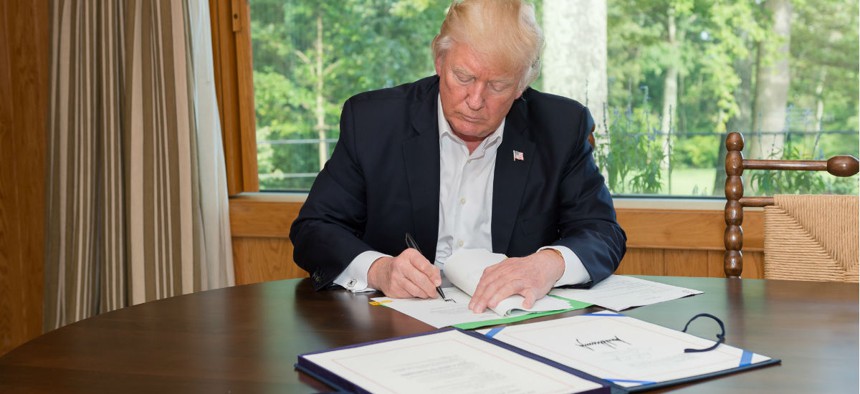 President Donald Trump signs the Hurricane Harvey Funding Bill.