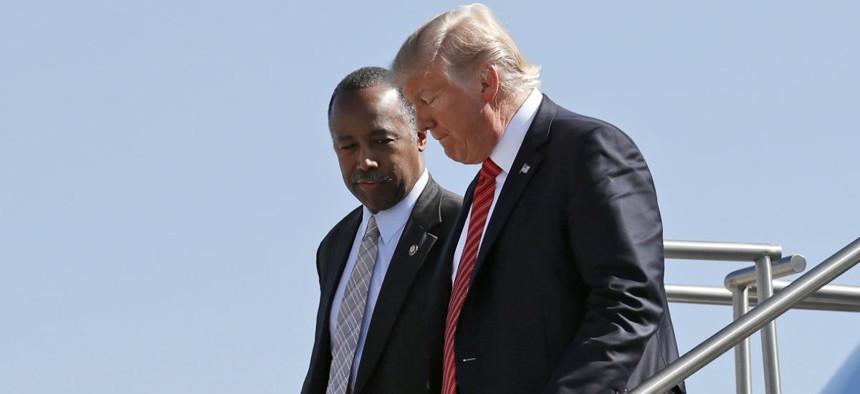 HUD Secretary Ben Carson (left) steps off Air Force One with President Trump in Nevada in August. 