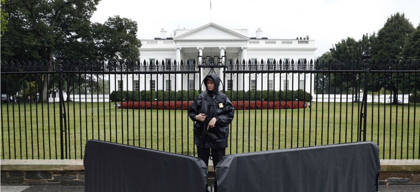A Secret Service agent stands guard outside the White House. 