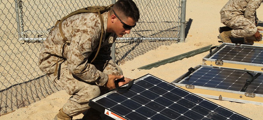 Marines work on solar panels in California in 2012.