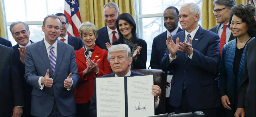President Trump signs an executive order on reorganizing government. 