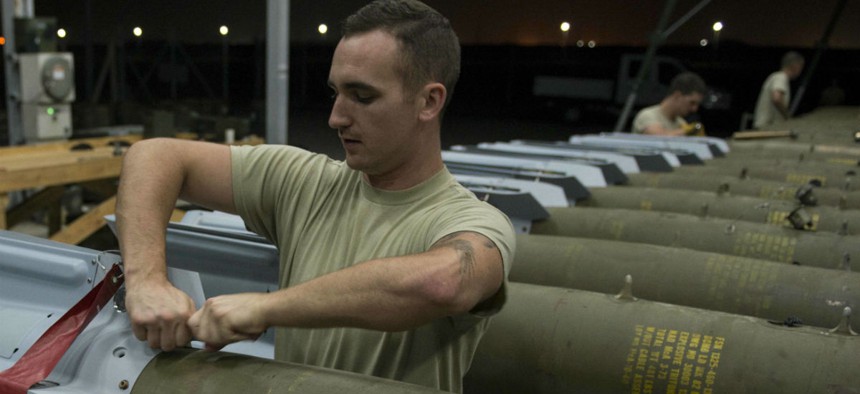 An airman attaches fins to GBU-12 Paveway II laser-guided bombs at Incirlik Air Base, Turkey, in 2016.