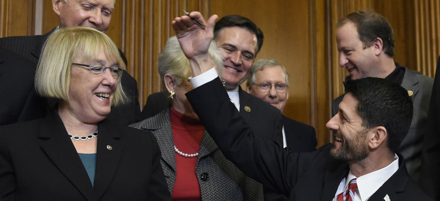 House Speaker Paul Ryan, R-Wis., and Sen. Patty Murray, D-Wash. (left), have long championed evidence-based policy. In this 2015 photo, Ryan signs legislation changing how schools are evaluated. 