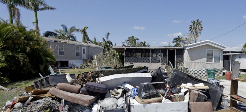 Debris from Hurricane Irma sits outside homes in Everglades City, Fla.